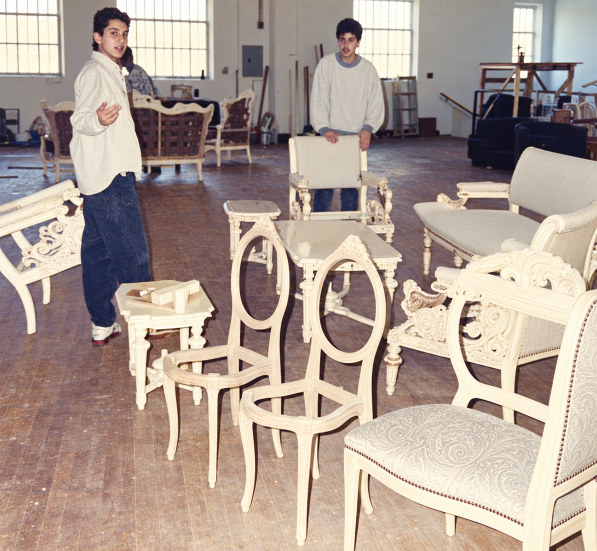 Restored family archive photograph of two men among carved chairs in the ABZ Bahsoun workshop